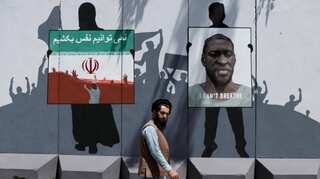 Afghan artists paint mural on blast wall in tribute to George Floyd