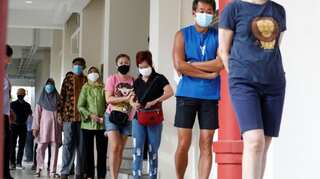 With gloves and masks, Singaporeans vote in general elections