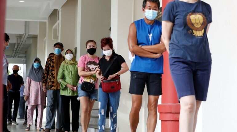 With gloves and masks, Singaporeans vote in general elections