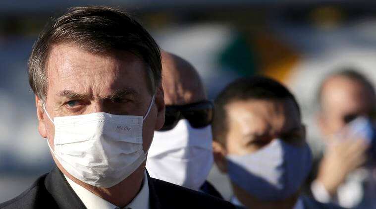 Jair Bolsonaro seen outside the Presidential palace wearing mask, maintaining social distancing