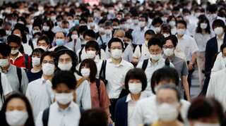 Tokyo may raise coronavirus alert as travel campaign comes under fire