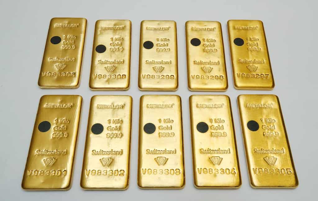 Gold firms near nine-year peak on weaker dollar, stimulus bets