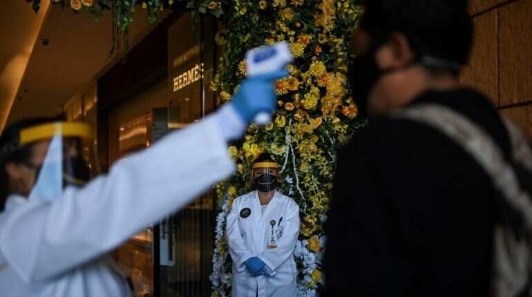 Do temperature checks achieve anything in limiting the transmission of COVID-19?