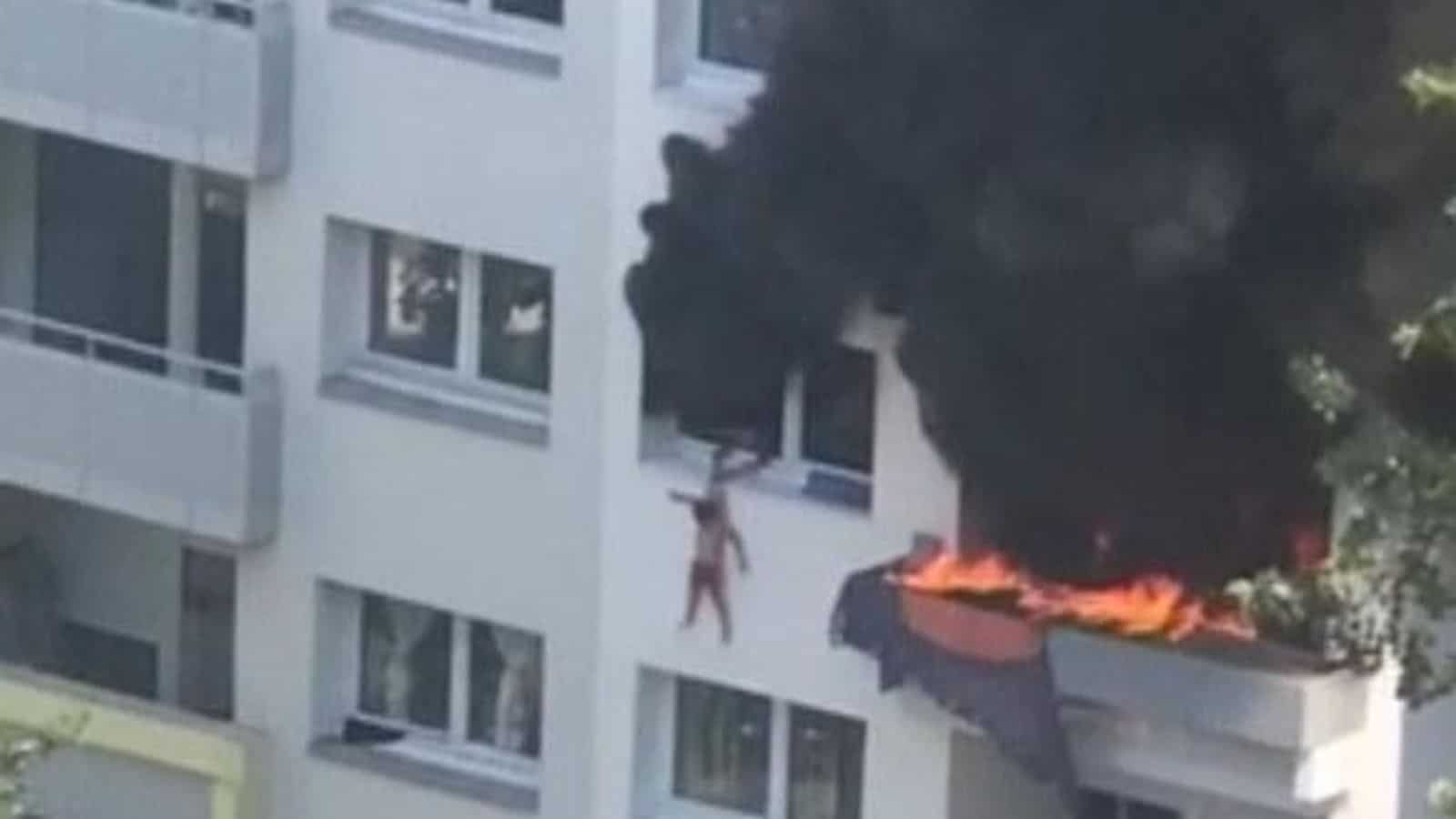 Watch: Brothers, 10 and three, caught by crowd after jumping from burning building Watch: Brothers, 10 and three, caught by crowd after jumping from burning building