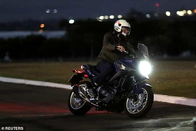 Despite being COVID positive, Bolsonaro rides motorcycle, chats up workers