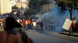 Beirut police fire tear gas as protesters regroup and two ministers quit