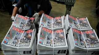 Hong Kong's Apple Daily vows to 'fight on' after owner arrested