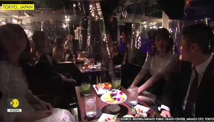 Tokyo bar uses "fish bowl" screens to lure back virus-wary clients