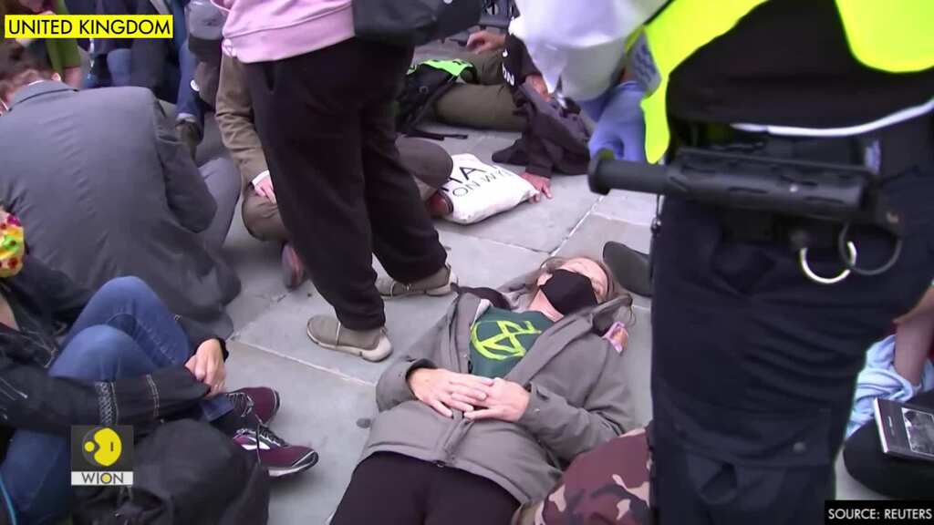 Climate activists glue themselves to street outside British parliament