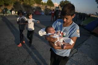 Greece ramps up emergency effort after Lesbos migrant camp fire, locals oppose plans