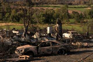 Firefighters in US northwest aided by weather, as winds drive California blaze
