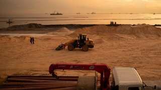 Polluted stretch of Manila Bay gets fake white sand makeover