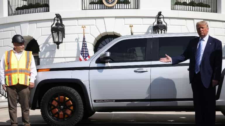 Donald Trump outside with a man with no mask