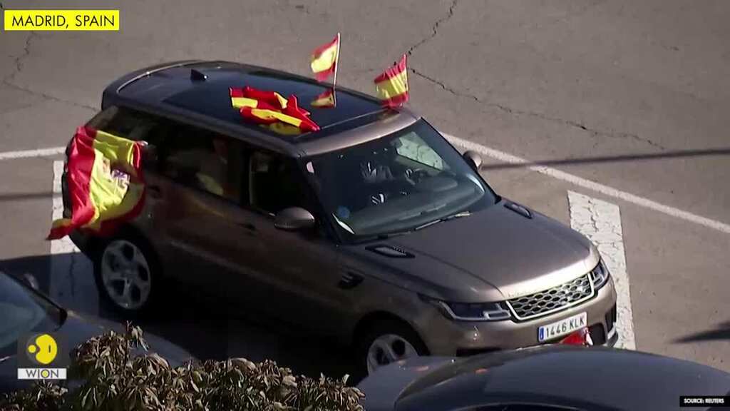 Waving Spanish flags, Madrid residents protest against lockdown