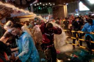 Thai riot police fire water cannon against protesters in Bangkok