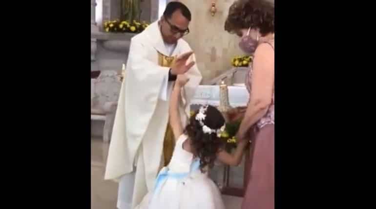 Watch| Little girl gives high-five to priest who raised hand to bless her