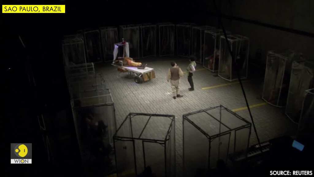 Spectators sit in plastic boxes as theatre returns to Brazil