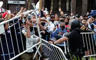 Fans confront riot police as millions gather to pay last respects to Maradona