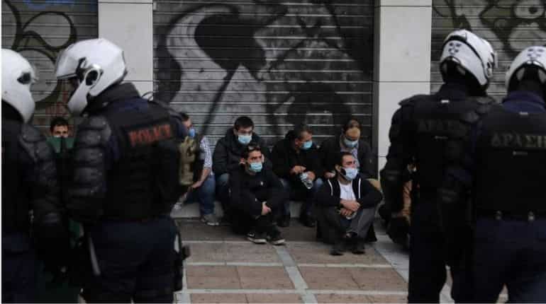 Greek police arrest dozens at march in memory of slain teen