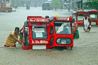 Two dead, hundreds flee floods in Philippine storm