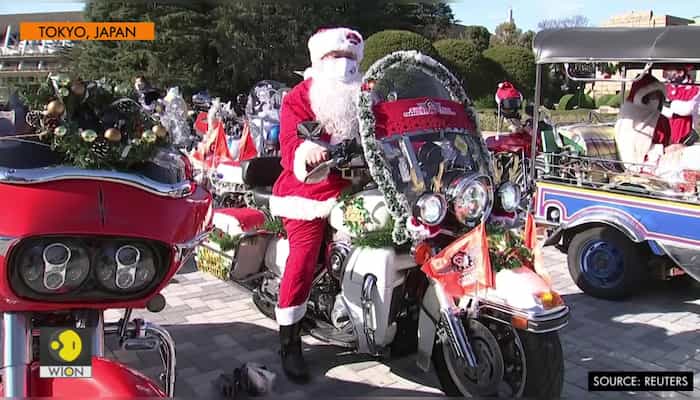 Santas on bikes parade through downtown Tokyo against child abuse