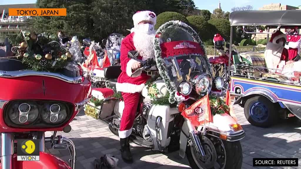 Santas on bikes parade through downtown Tokyo against child abuse