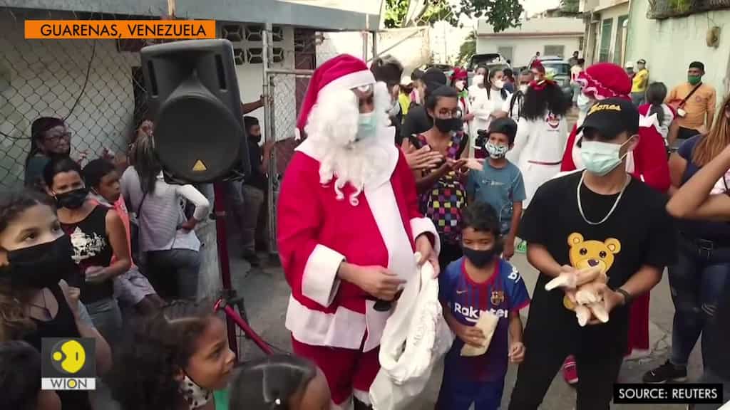 Santa gives food to poor hit by pandemic and recession in Venezuela
