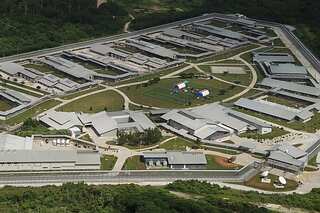 Australia vows to 'restore order' on immigration detention island