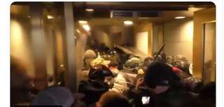Video shows officer crushed against door by mob storming US Capitol