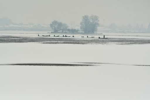 Fishing in the snow at Dal Lake
