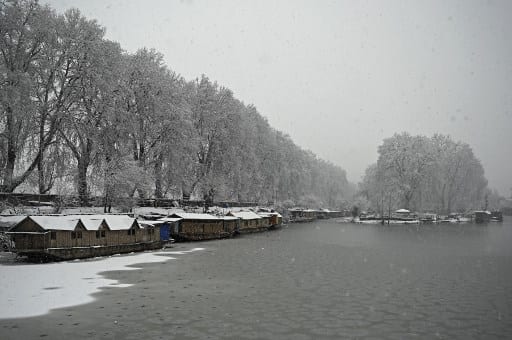 Snow covered boats in Dal Lake