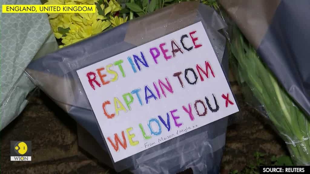 Mourners lay flowers outside Captain Tom's home