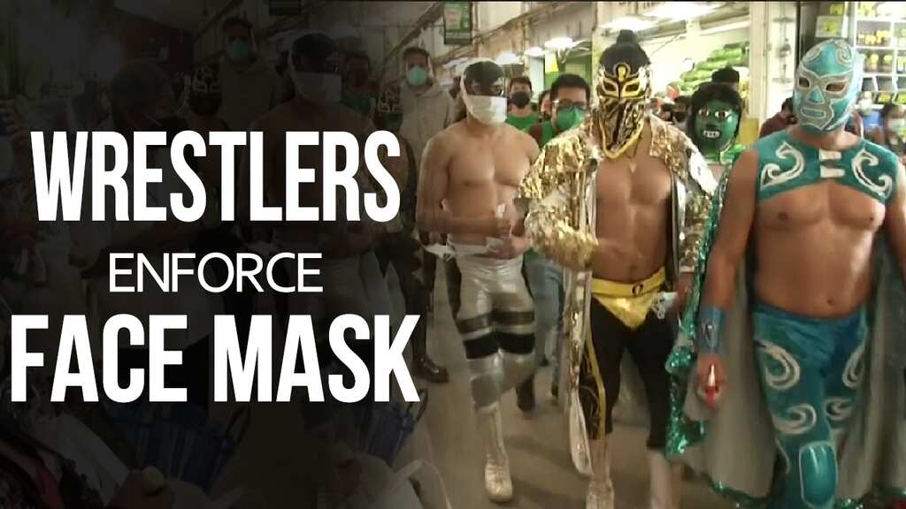 Wrestlers enforce face mask rules in Mexican market