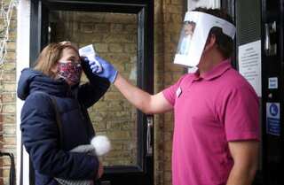 UK achieves key vaccination target as pubs, shops and salons reopen