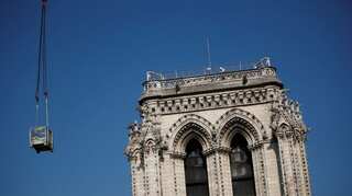 Macron scales Notre-Dame's rooftop two years after cathedral fire