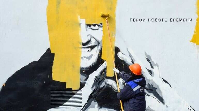 Russian authorities paint over a large mural of Alexei Navalny in St Petersburg