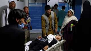 Afghan school blast toll rises to 58, families bury victims