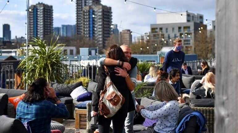 Mask free and hugs: How the West is rushing towards exit from pandemic lockdowns