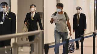 Japanese journalist held in Myanmar arrives in Tokyo