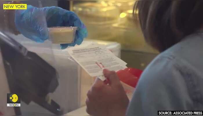 New Yorkers flash vaccine card for freebies
