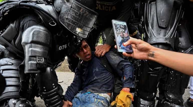 Colombia to probe police officers who stood by as civilians shot at protesters Colombia to probe police officers who stood by as civilians shot at protesters