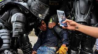 Colombia to probe police officers who stood by as civilians shot at protesters