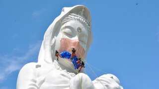 Giant Buddhist goddess in Japan gets 35kg face mask to pray for end of COVID-19