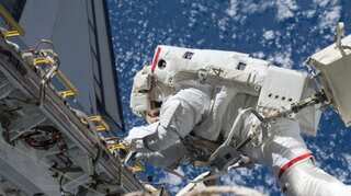 Astronauts spacewalk on International Space Station to boost its solar power