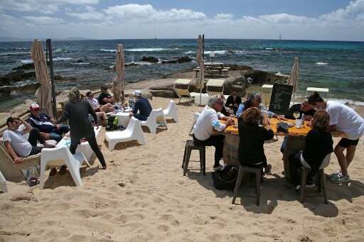 Amid vaccination, France drops wearing masks outdoors