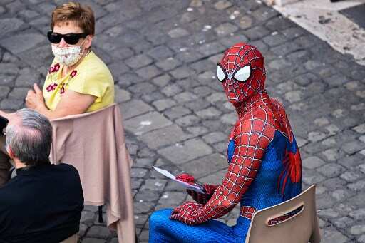 Man wearing spider man costume waits for Pope