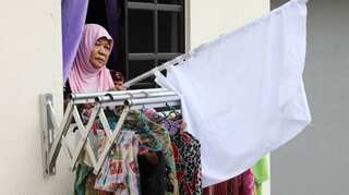 Malaysians turn to white flags to seek help as lockdown torments