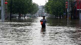 China floods: Mother dies saving baby from mudslide in Henan