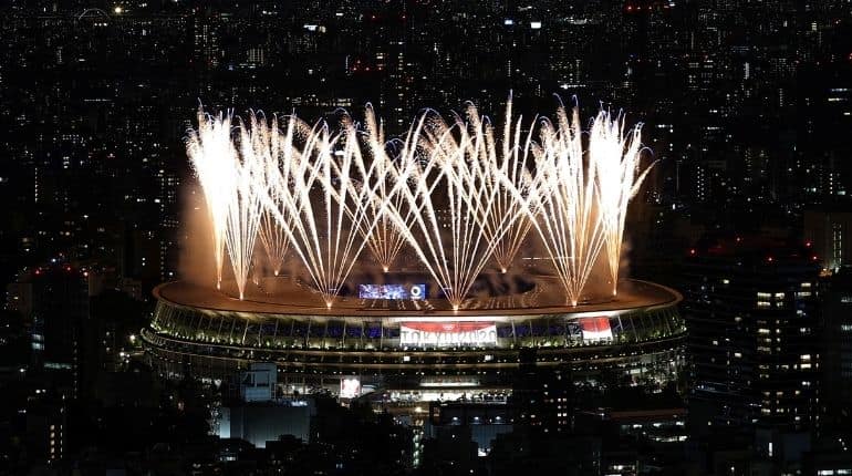 Olympics-Fireworks get Tokyo's no-frills opening ceremony underway