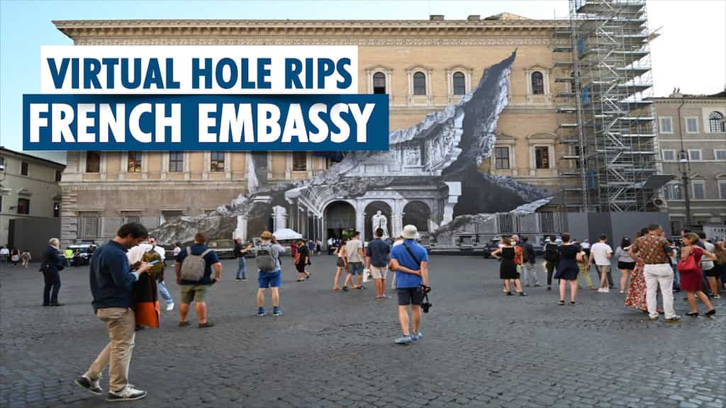 Artist JR rips a hole through French embassy in Rome